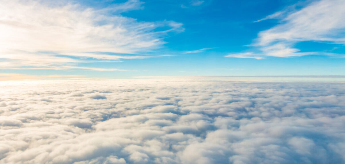 Sunrise above clouds from airplane window .