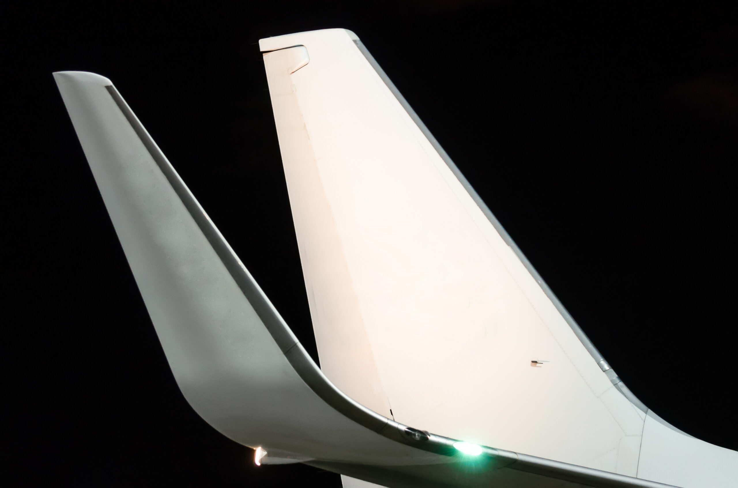 Wings and tail with night lights at the airport.